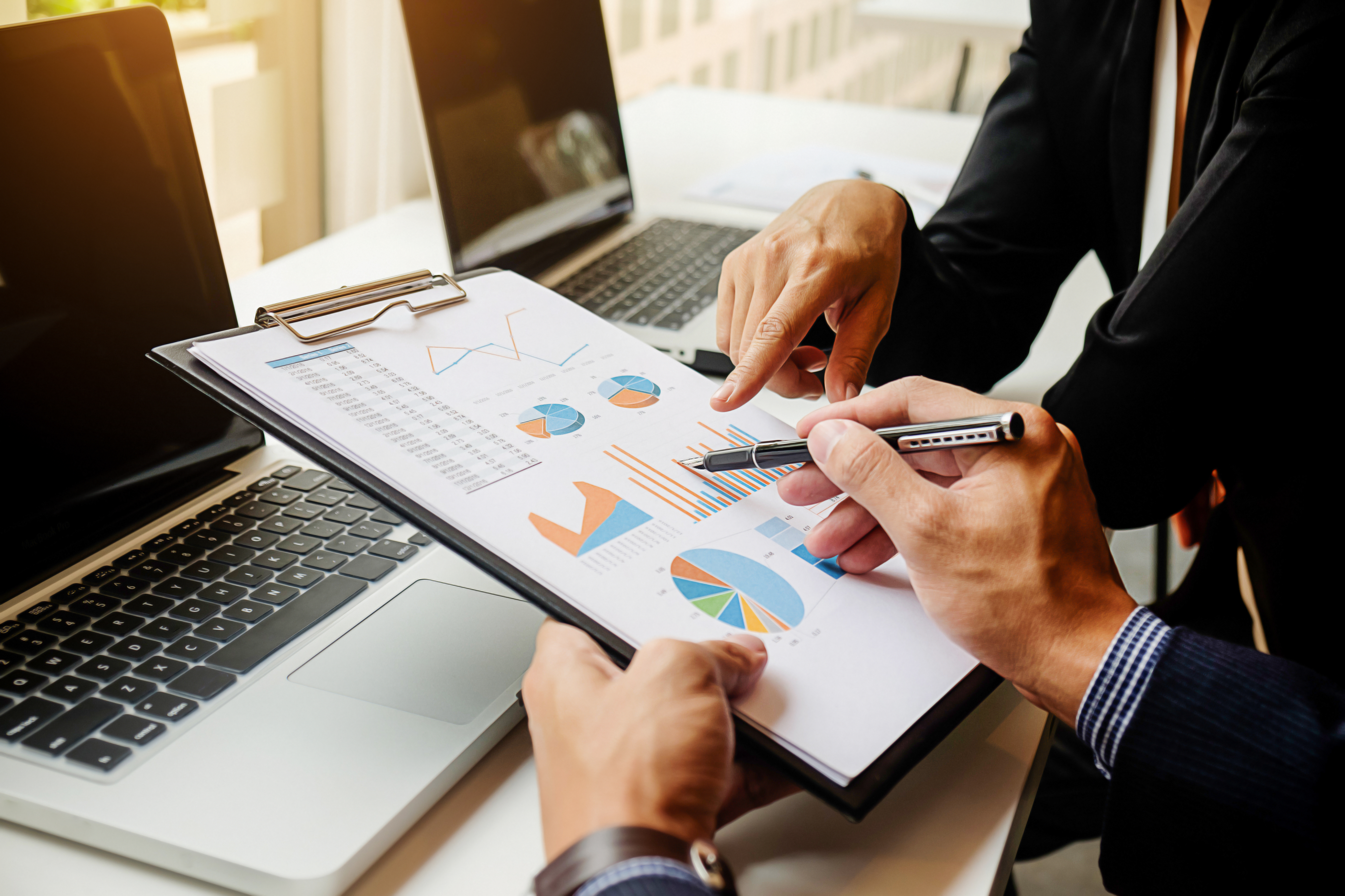 workplace-results-professional-report-accounting-during Business concept. Business people discussing the charts and graphs showing the results of their successful teamwork. Selective focus.